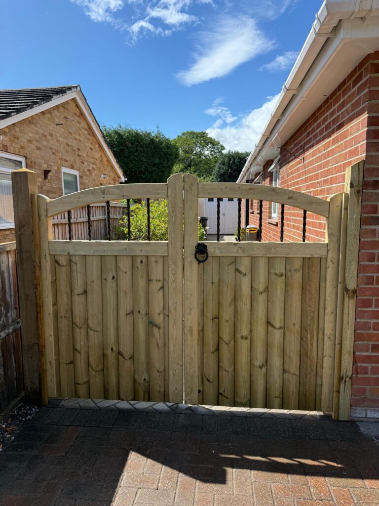 A pair of curve top softwood entrance gates Hythe