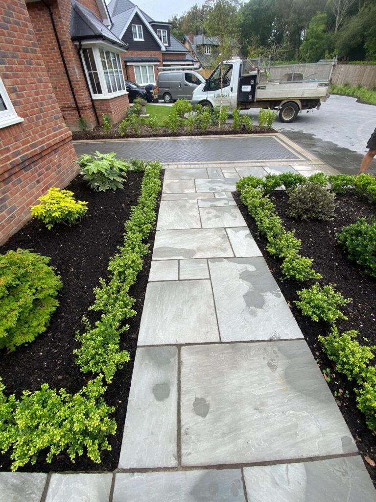 Indian sandstone paving new lawns, raised beds done for a lady in Barton on sea 1