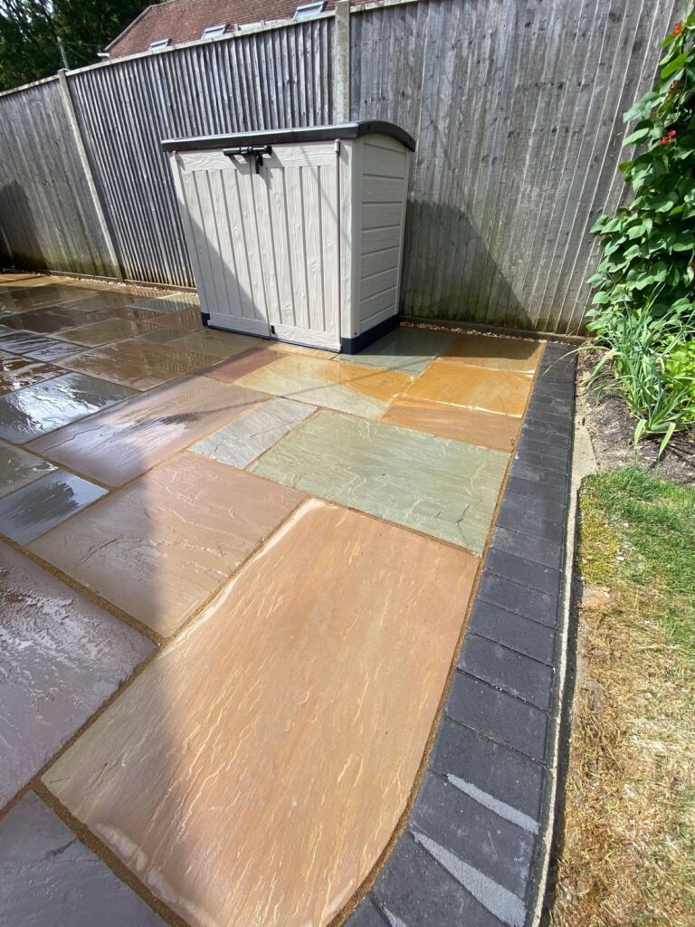 Indian sandstone paving with a charcoal pavia edge in Walkford
