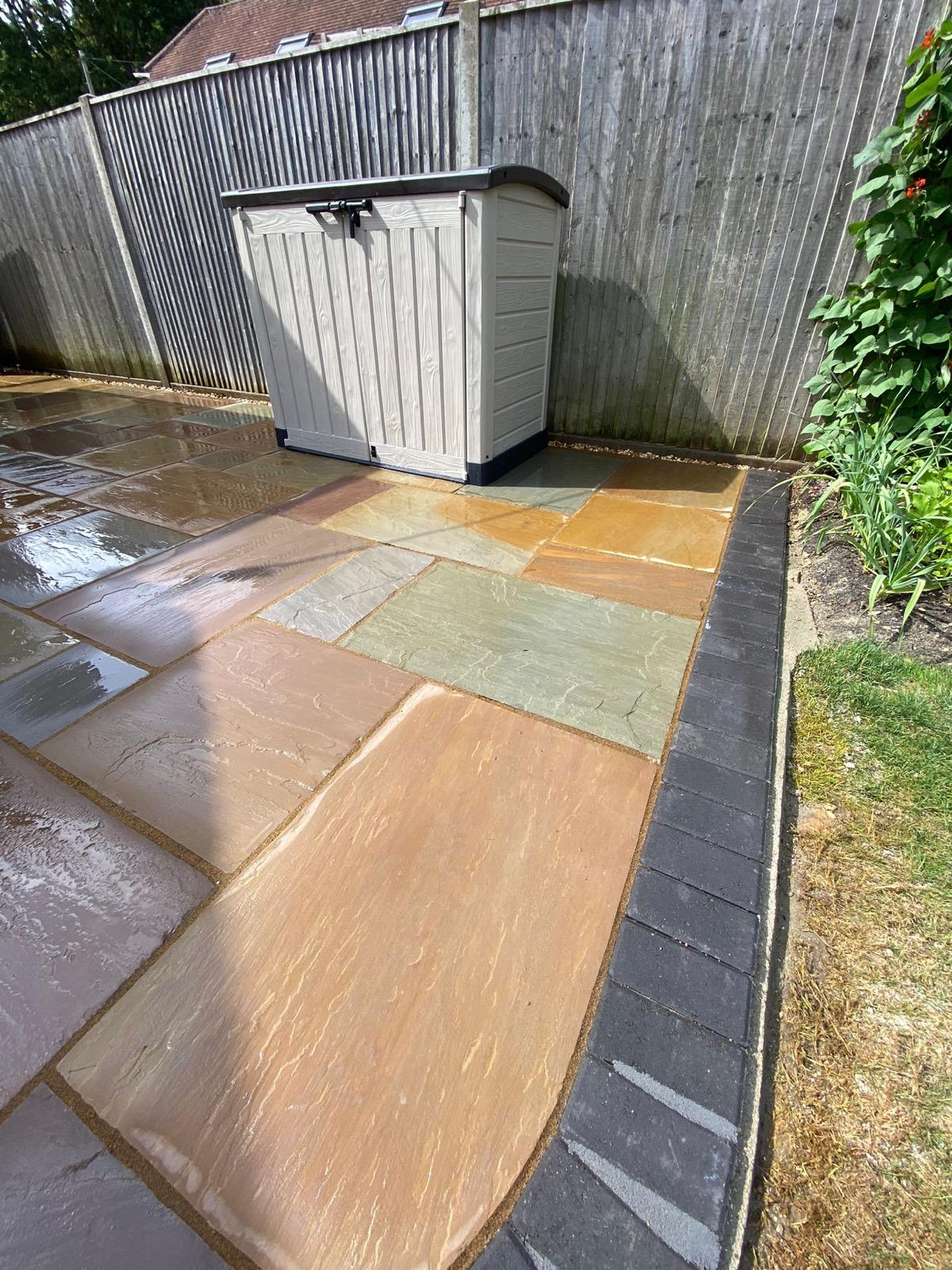 Indian sandstone paving with a charcoal pavia edge in Walkford