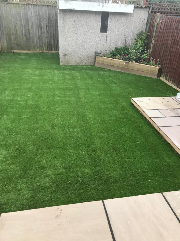 Nam grass laid with new patio Indian sandstone buff project packs in New Milton