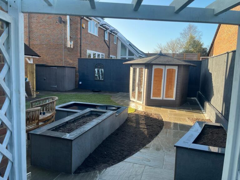 Landscaped garden with lawn and planted borders by Turners